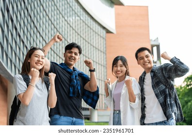 Group of happy young entrepreneurs with hands up and laughing to celebrate and excited success for achievements obtained. Undergraduate students celebrate success after end project, teamwork concept - Powered by Shutterstock