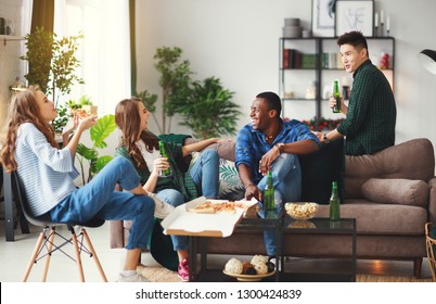 Group Of Happy Young  Friends With Beer And Pizza At Home