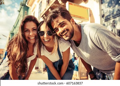 Group Of Happy Young Friends Hangout On City Street.Sunset.Close Up Image.