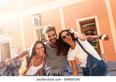 Group Of Happy Young Friends Having Fun On City Street.Sunset.