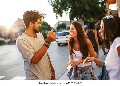 Group Of Happy Young Friends Having Fun On City Street.Sunset.