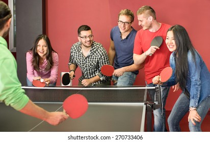 Group Of Happy Young Friends Playing Ping Pong Table Tennis - Fun Moment In Game Room Of Traveler Youth Hostel - Concept Of Vintage Sport And Genuine Emotions - Main Focus On Two Guys With Eye Glasses