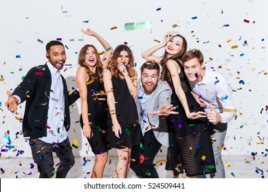 Group Of Happy Young People Celebrating And Having Fun Together Over White Background