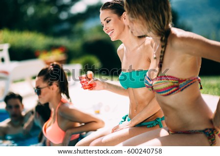 Group of happy young people enjoying summer at pool