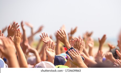 Group Of Happy Young People With Hands Up To The Sky