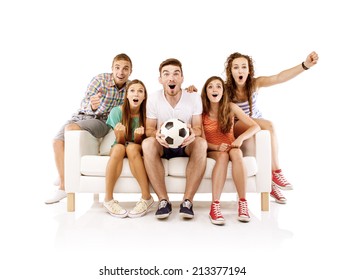 Group Of Happy Young People Sitting On Sofa And Holding Soccer Ball, Isolated On White Background. Best Friends