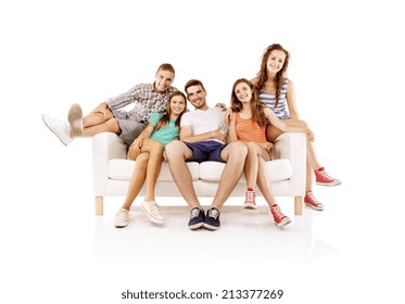 Group Of Happy Young People Sitting On Sofa, Isolated On White Background. Best Friends