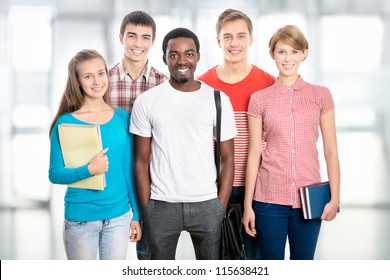 Group of happy young students in a university