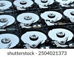 Group of hard disk drives. Many Open Hard drives. Close-up of the inside of PC hard drives. Technology background.