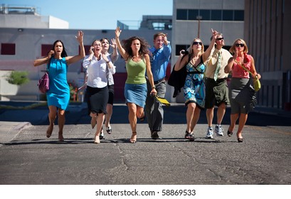 Group Of Hard Working Business Men And Women Run Down City Street.