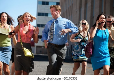 Group Of Hard Working Business Men And Women Run Down City Street.