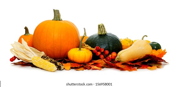 Group of harvest vegetables with autumn leaves over white