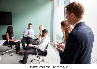 Group Having Discussion At Graduate Recruitment Assessment Day Whilst Being Observed By Recruitment Team - Shutterstock ID 1229695522