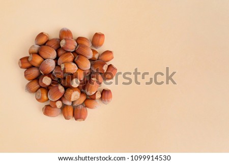 Group of hazelnuts on yellow background