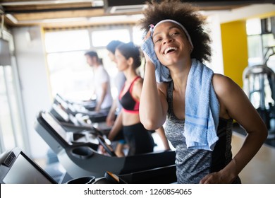 Group Of Healthy Fit People At The Gym Exercising