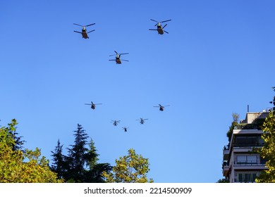 Group Of Helicopters Flying Low In Formation In A Military Parade Through The City Of Madrid, Spain.