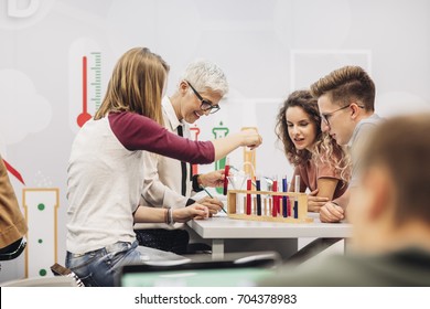 Group Of High School Students Doing Science Experiments With Their Chemistry Teacher.