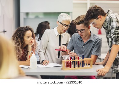 Group of high school students doing experiments on chemistry class with their teacher. - Powered by Shutterstock