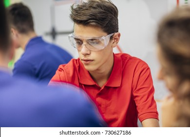 Group of high school students doing experiments with liquids on chemistry class. - Powered by Shutterstock