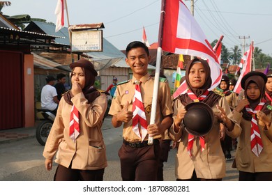 A group of high school students dressed in scout uniforms participating in Indonesia's national independence day parade. Jambi, Indonesia - August 2018. - Shutterstock ID 1870880281