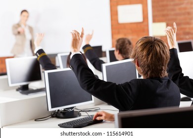 Group Of High School Students Hands Up In Computer Class