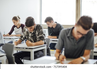 Group of high school students having test at classroom.