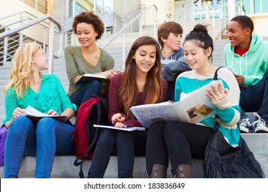 Group Of High School Students Sitting Outside Building