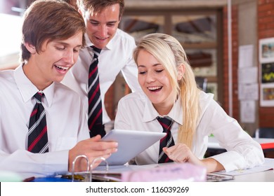 Group Of High School Students Using Tablet Computer In Classroom