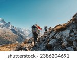 Group of hiker hiking on mountain trail with difficult to Lac Blanc amidst French alps on sunny day at France
