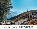 Group of hiker hiking on summit trail to Lac Blanc amidst the French alps on sunny day at Haute savoie, France