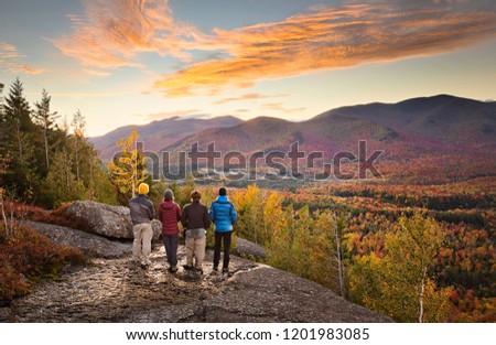 group of hikers enjoying the view in the Adirondacks