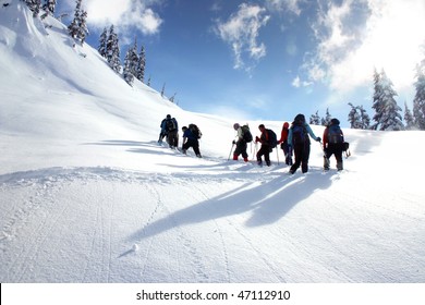 A Group Hikers Are Snowshoeing On Snow Mountain In BC, Canada.