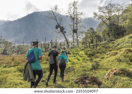group of hikers with their backpacks in the middle of the tropical cloud forest on a cloudy day on the slopes of the Turrialba Volcano