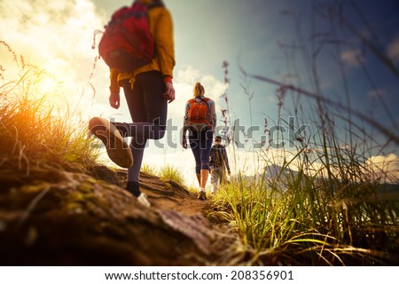 Group of hikers walking in mountains. Edges of the image are blurred