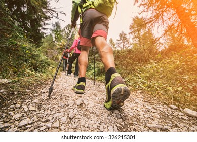 Group Of Hikers Walking In The Nature At Sunset - Friends Taking An Excursion On A Mountain,close Up On Shoe