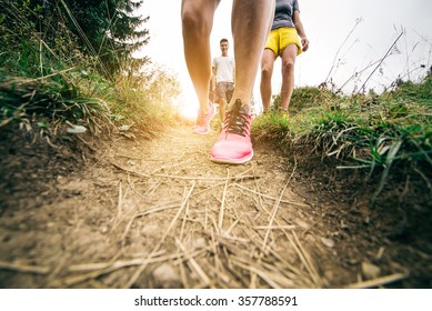 Group Of Hikers Walking In The Nature At Sunset - Friends Taking An Excursion On A Mountain,close Up On Shoes