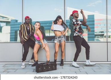 Group Of Hip Hop Dancers Permorming Their Dance. Crew Making Show In An Urban Place