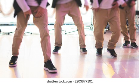 Group Of Hip-hop Dancers Performance On A Stage, Modern Contemporary Street Dance With Break Dancing In Studio, Hip Hop Dance Training  In A Ballroom, Legs In Sneakers Close Up