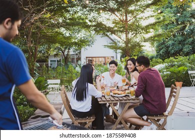 Group holiday party of asian people Eating dinner and drinking beer at home - Powered by Shutterstock