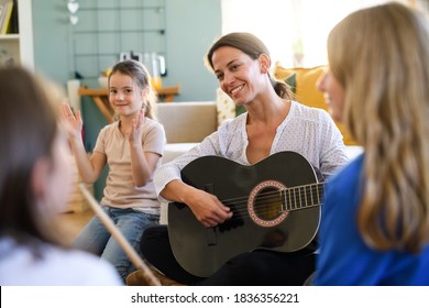 Group Of Homeschooling Children With Teacher Having Music Lesson Indoors, Coronavirus Concept.