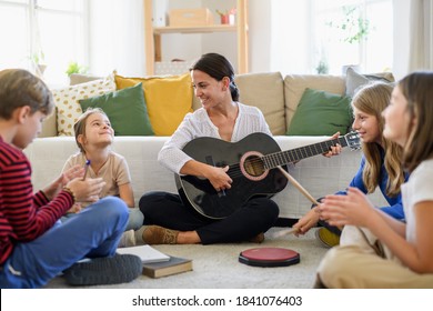 Group Of Homeschooling Children With Teacher Having Music Lesson Indoors, Coronavirus Concept.