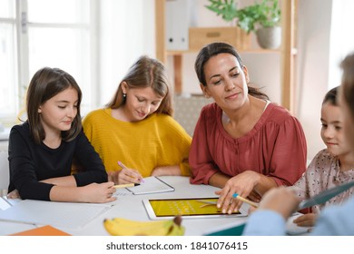 Group Of Homeschooling Children With Teacher Studying Indoors, Coronavirus Concept.