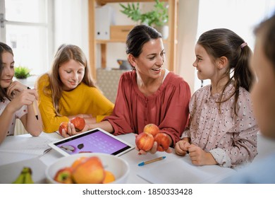 Group Of Homeschooling Children With Teacher Studying Indoors, Coronavirus Concept.