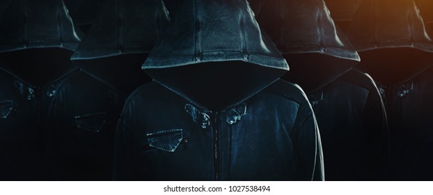 Group of hooded computer hackers with obscured faces lined up in formation as army soldiers. Programmers, internet experts and cybersecurity technicians joined for common goal. - Powered by Shutterstock - Get 15% off with code: PIKWIZARD15