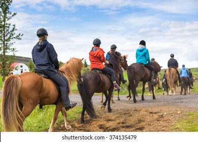 Group of horseback riders ride  in Iceland - Shutterstock ID 374135479