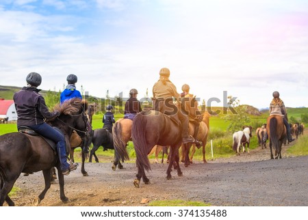 Group of horseback riders ride  in Iceland
