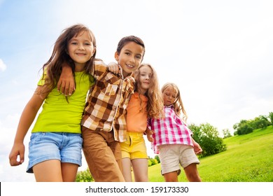 Group Of Hugging 6 ,7 Years Kids Standing And Hugging In The Park On Summer Day