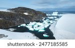 Group of icebergs melting glacier floating in Antarctic mountain rock canyon bay frozen river. Polar winter ocean landscape in sunny day. Antarctica travel exploration. Aerial view rise up panorama.