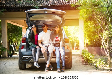 Group Of Indian Asian Young And Attractive Friends Sitting In The Open Trunk Of A Car, A Summer Road Trip