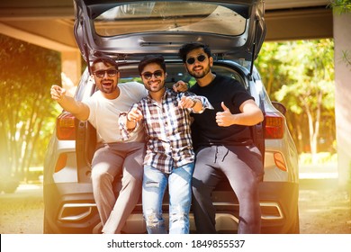 Group Of Indian Asian Young And Attractive Friends Sitting In The Open Trunk Of A Car, A Summer Road Trip